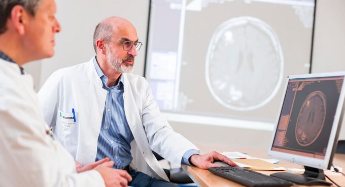 Ärzte betrachten und besprechen MRT-Bild auf dem Computer